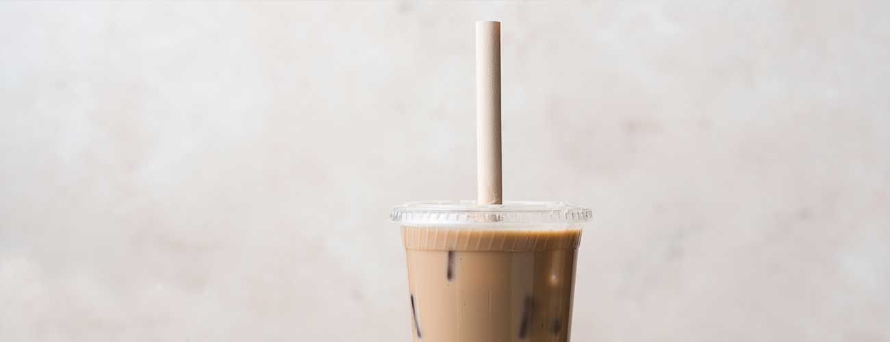 Boba tea, served with a bamboo boba straw.
